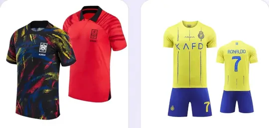Two football shirts, one dark patterned and one red, laid side by side